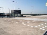 an empty parking lot has signs indicating parking spots and lines on the ground for parking