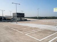 an empty parking lot has signs indicating parking spots and lines on the ground for parking