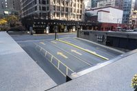 an empty parking lot with yellow arrows painted on the street side of it's curb