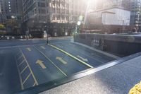 an empty parking lot with yellow arrows painted on the street side of it's curb