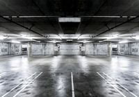 empty parking space with lights, parking spaces and concrete walls have been changed to give this photo look a much grungy feel