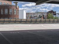 an empty parking space in front of buildings and trees is marked on the road to indicate people who are waiting for their food