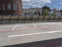 an empty parking space in front of buildings and trees is marked on the road to indicate people who are waiting for their food