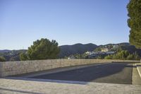 empty parking space near mountain area, with large building in background and mountains in distance