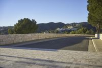 empty parking space near mountain area, with large building in background and mountains in distance