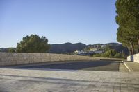 empty parking space near mountain area, with large building in background and mountains in distance