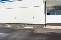 a empty parking space with a blue sky and some trees in the background for urban purposes