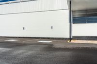 a empty parking space with a blue sky and some trees in the background for urban purposes