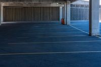 a empty parking space with no cars parked on it outside a large building with some walls