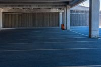 a empty parking space with no cars parked on it outside a large building with some walls