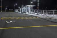 empty parking space with no traffic on a dark night time scene in an urban area