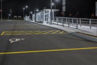 empty parking space with no traffic on a dark night time scene in an urban area