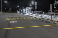 empty parking space with no traffic on a dark night time scene in an urban area