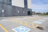 an empty parking lot with yellow and blue handicapped lanes on the road near the building