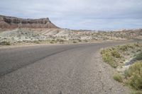 an empty paved highway in a barren, mostly barren area in the wild side of the country