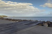 the pier is empty and ready to be used for surfing by the water or in the sun