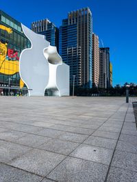 the apple logo is seen on the side of an empty plaza in a large city