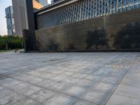 the empty public square has some light reflected on it, and no one is in