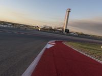 a race track is empty and ready to be ridden down into the air at dusk