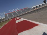 an empty racetrack with the track painted red and white stripes for racing teams to practice
