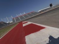 an empty racetrack with the track painted red and white stripes for racing teams to practice