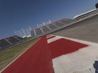 an empty racetrack with the track painted red and white stripes for racing teams to practice