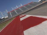 an empty racetrack with the track painted red and white stripes for racing teams to practice