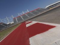 an empty racetrack with the track painted red and white stripes for racing teams to practice