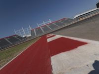 an empty racetrack with the track painted red and white stripes for racing teams to practice