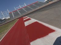an empty racetrack with the track painted red and white stripes for racing teams to practice