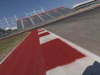an empty racetrack with the track painted red and white stripes for racing teams to practice