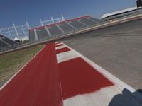 an empty racetrack with the track painted red and white stripes for racing teams to practice