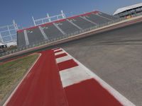 an empty racetrack with the track painted red and white stripes for racing teams to practice