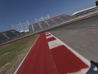 an empty racetrack with the track painted red and white stripes for racing teams to practice