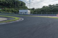 the track is empty as the cars race up the hill towards the camera in this photo