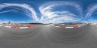 this is a panorama of an empty track with a camera attached to it and smoke trails coming out of the air