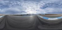 a panoramic view looking down at an empty runway, with a half pipe as the centre