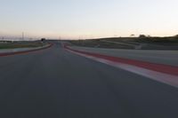 the view from the driver's seat of a car driving on an empty racetrack