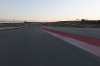 the view from the driver's seat of a car driving on an empty racetrack