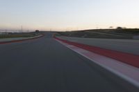 the view from the driver's seat of a car driving on an empty racetrack