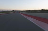 the view from the driver's seat of a car driving on an empty racetrack