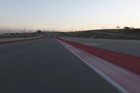 the view from the driver's seat of a car driving on an empty racetrack