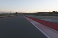 the view from the driver's seat of a car driving on an empty racetrack