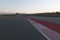 the view from the driver's seat of a car driving on an empty racetrack