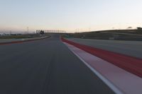 the view from the driver's seat of a car driving on an empty racetrack