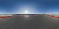 the sun is shining over an empty racetrack as it makes its way across the corner