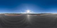 a photo looking down into the sky at an empty racetrack with a curve around it