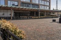 the sidewalk outside of an empty restaurant on a sunny day in the city of boston