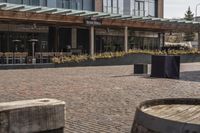 the sidewalk outside of an empty restaurant on a sunny day in the city of boston