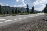 the road is empty and paved with yellow markings on the pavement that make it clear